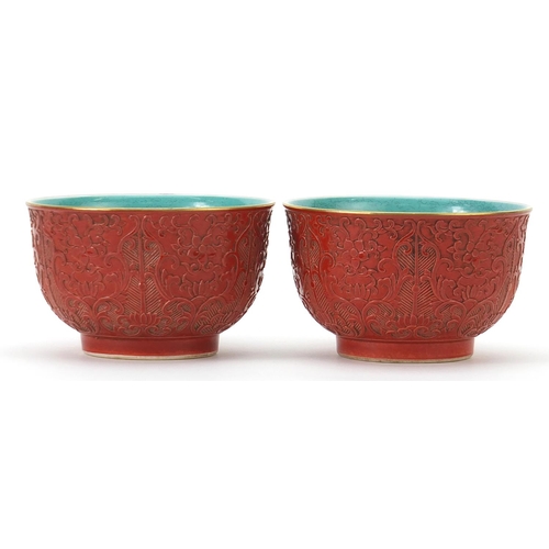 163 - Pair of Chinese faux cinnabar lacquer porcelain bowls, four figure character marks to the bases, eac... 