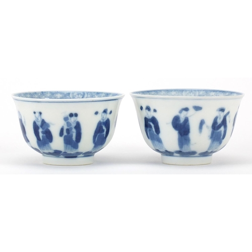 17 - Pair of Chinese blue and white porcelain tea bowls hand painted with figures, four figure character ... 