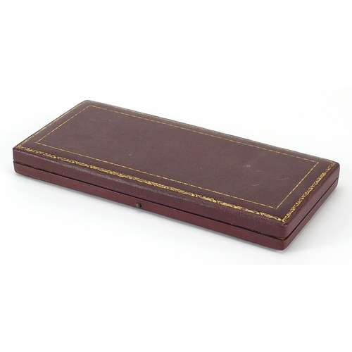 320 - Elizabeth II 1953 specimen coin set housed in a velvet lined tooled leather case, 20cm wide