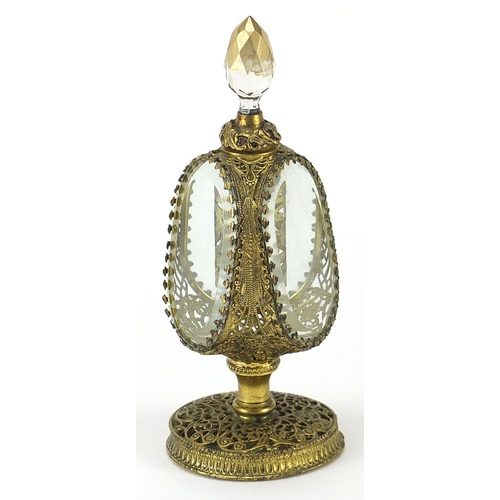 425 - Ornate brass filigree scent bottle with bevelled glass panels, 18.5cm high