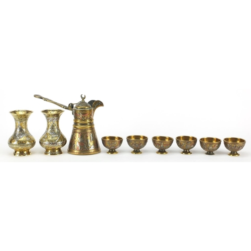 219 - Islamic brass Cairoware with silver inlay comprising coffee pot, six cups on tray and pair of vases,... 