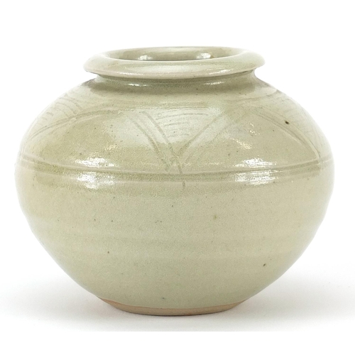 85 - Mike Dodd studio pottery vase having a celadon glaze with incised motifs, 8.5cm high