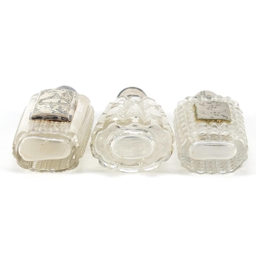 68 - Three Dutch silver mounted cut glass scent bottles, the largest 9.5cm high