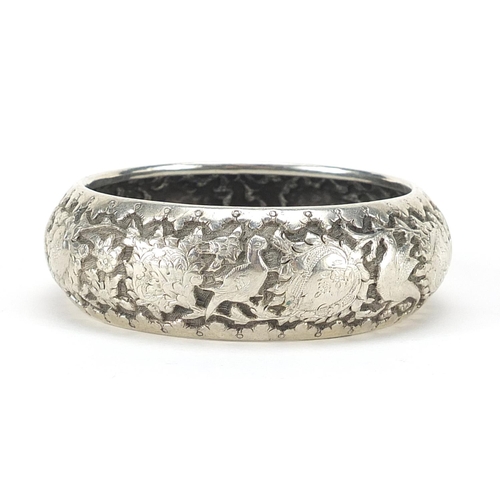 1157 - Persian silver coloured metal cuff bracelet embossed with birds amongst foliage, 7.5cm in diameter, ... 