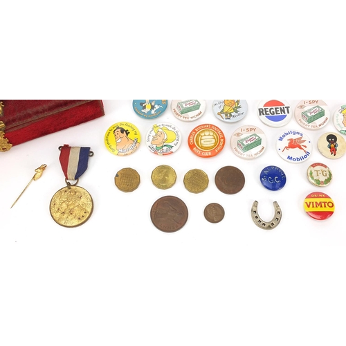 1302 - Vintage and later badges, some advertising including Wills Woodbine and Mobil Gas arranged in a red ... 