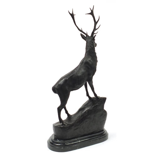 372 - Large patinated bronze stag raised on a shaped marble base, 74cm high