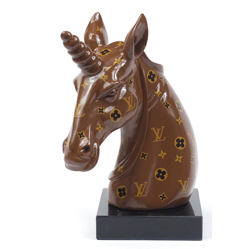 510 - Louis Vuitton design unicorn bust raised on a square black glass base, 47cm high