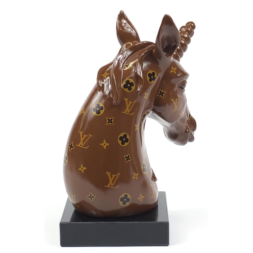 510 - Louis Vuitton design unicorn bust raised on a square black glass base, 47cm high