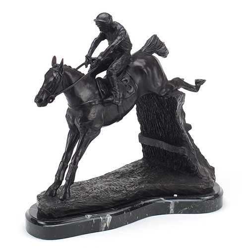 433 - Large patinated bronze jockey on horseback raised on a shaped marble base, 33cm high