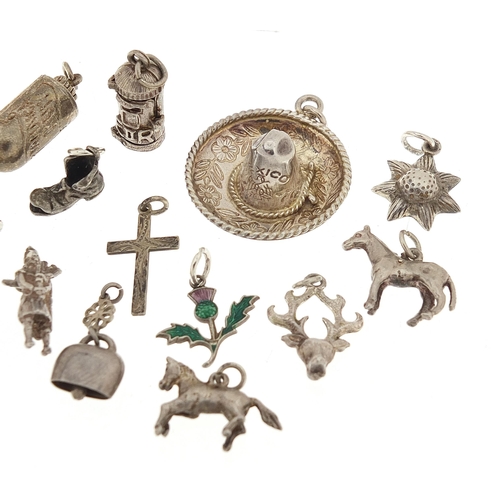 1080 - Nineteen silver charms including bottle of rum, post box and sombrero hat, the largest 2.8cm in diam... 