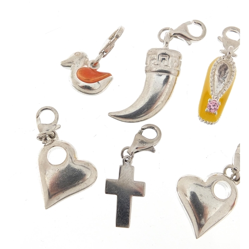 1068 - Ten silver charms, five enamel including love hearts and ducks, the largest 3.8cm high, total weight... 