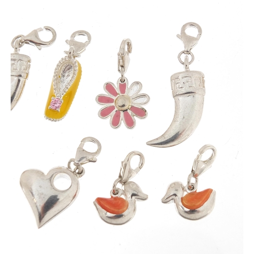 1068 - Ten silver charms, five enamel including love hearts and ducks, the largest 3.8cm high, total weight... 