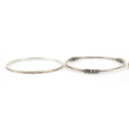 1054 - Four silver bangles, 67.6g