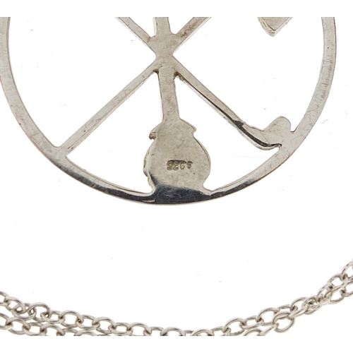 1065 - Silver golfing interest no 1 pendant on a silver coloured metal necklace, the pendant 2.8cm in diame... 