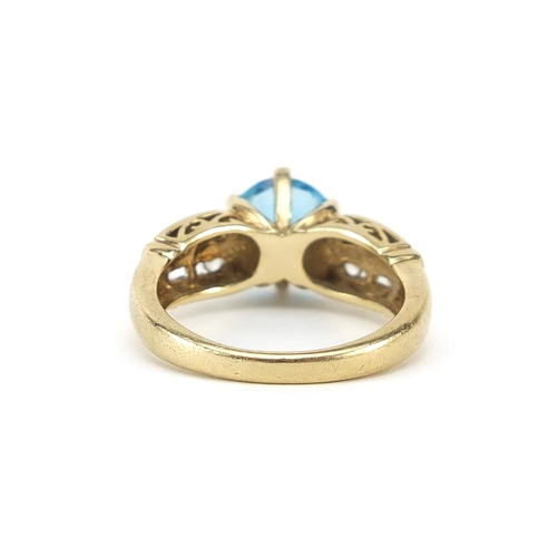 786 - 9ct gold blue topaz solitaire ring set with white sapphires to the shoulders, size N, 4.8g