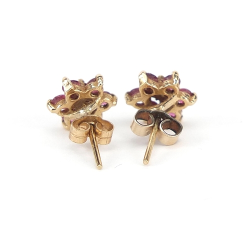 791 - Pair of 9ct gold ruby and diamond flower head stud earrings, 8mm in diameter, 1.0g