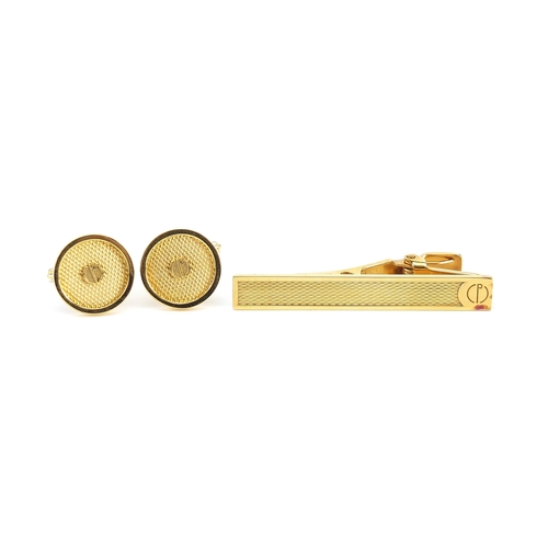 1074 - Dunhill, pair of gold plated cufflinks and tie clip with fitted box, the tie clip 5.2cm in length