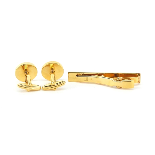 1074 - Dunhill, pair of gold plated cufflinks and tie clip with fitted box, the tie clip 5.2cm in length