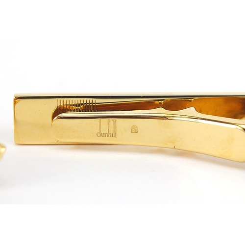 1074 - Dunhill, pair of gold plated cufflinks and tie clip with fitted box, the tie clip 5.2cm in length