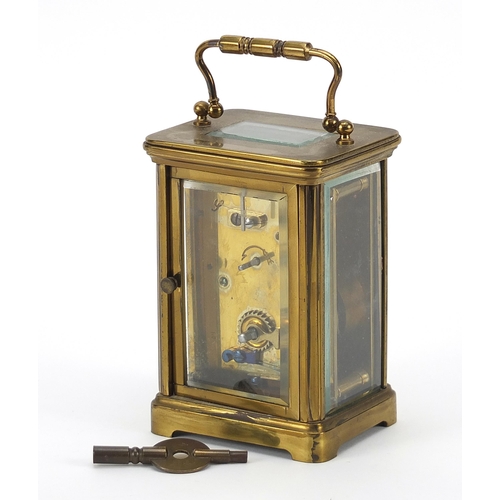 391 - Brass cased carriage clock with enamelled dial and Roman numerals, 11cm high