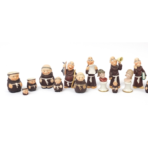 1326 - Collectable china including Goebel monks and a Nao dog group numbered 1480, the largest 15cm high