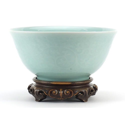 93 - Chinese porcelain bowl on carved hardwood stand having a celadon glaze decorated under glaze with fl... 