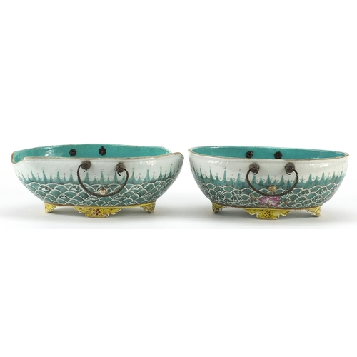 19 - Two Chinese porcelain four footed bowls with metal handles, each finely hand painted with crashing w... 