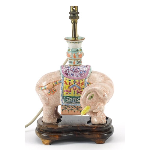 43 - Chinese porcelain elephant table lamp raised on hardwood stand, hand painted in the famille rose pal... 