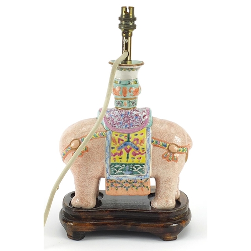 43 - Chinese porcelain elephant table lamp raised on hardwood stand, hand painted in the famille rose pal... 