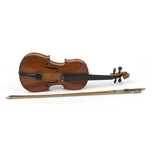 711 - Wooden violin with bow and protective carry case, the violin bearing a paper label The Buckingham Vi... 