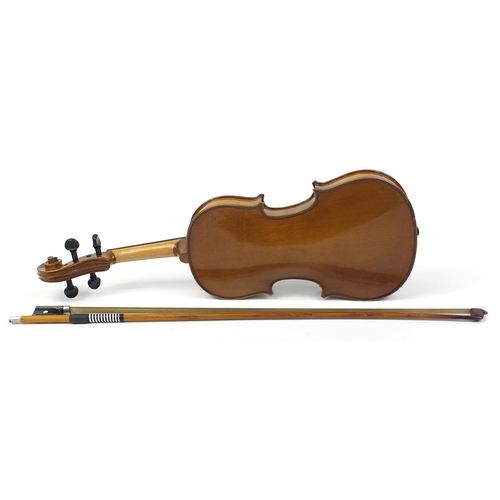 711 - Wooden violin with bow and protective carry case, the violin bearing a paper label The Buckingham Vi... 