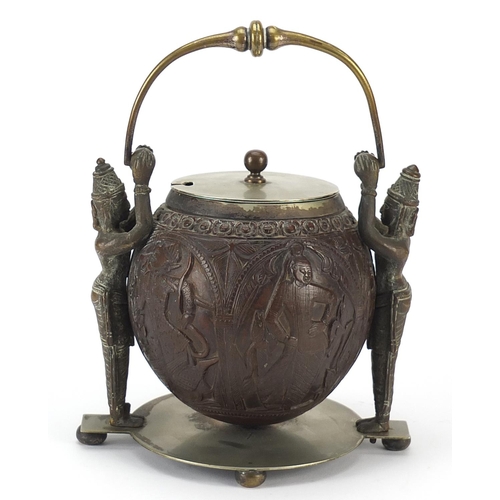 280 - Anglo Indian carved coconut tea caddy with bronzed figural supports and swing handle, impressed mark... 