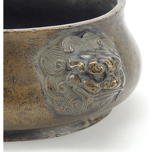 120 - Chinese patinated bronze censer with Foo dog head handles, character marks to the base, 20cm wide