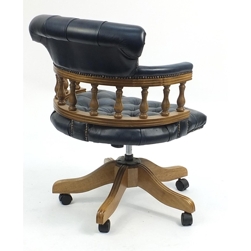 667 - Lightwood framed Captain's chair with blue leather button back upholstery, 90cm high