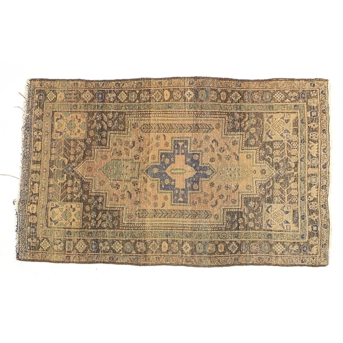 673 - Brown, blue and beige ground rug with all over geometric design, 205cm x 128cm