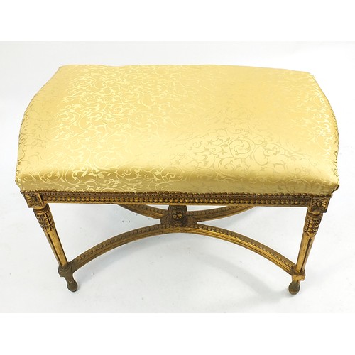 665 - Large French design gilt stool with gold floral upholstery, 68cm H x 93cm W x 50cm D