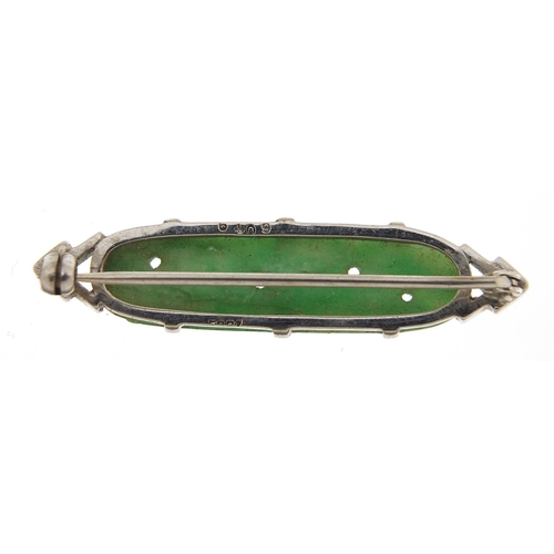 910 - 18ct white gold and Chinese carved green jade brooch, 4cm wide, 5.4g