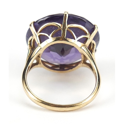 911 - Large 9ct gold blue/purple stone ring, possibly alexandrite, 19mm in diameter, size L, 8.9g