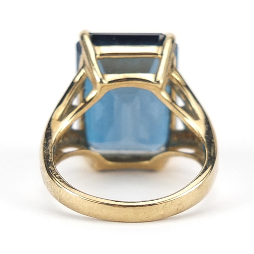 925 - Large 9ct gold blue topaz ring with diamond set shoulders, the topaz 17mm x 13mm, size P, 8.7g