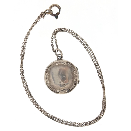 1026 - Circular silver locket on a silver necklace, the locket hallmarked Birmingham 1916, 2.2cm in diamete... 