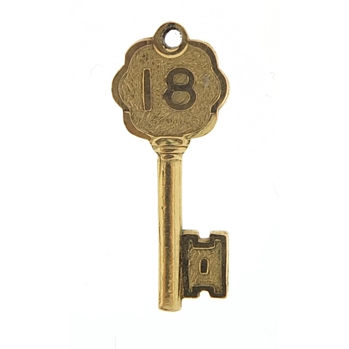 993 - 9ct gold 18 key charm, 2.5cm in length, 1.7g