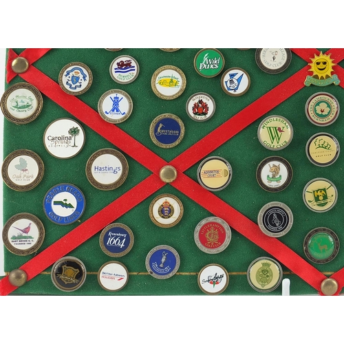 1286 - Collection of vintage and later golf badges mounted on a board