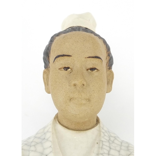 1380 - Chinese pottery crackle glazed figure of a young male in a robe, 19.5cm high