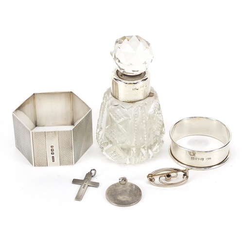 1399 - Silver objects comprising two napkin rings, two pendants, a brooch and cut glass scent bottle with s... 