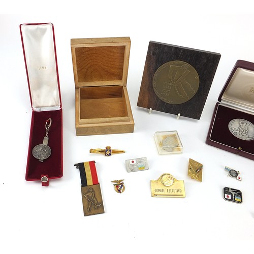 1342 - Group of hockey medals and badges, the largest 8cm in diameter