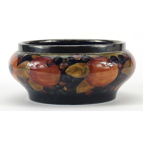 325A - William Moorcroft pottery bowl with silver plated rim hand painted with flowers, 21cm in diameter