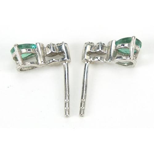 936 - Pair of silver tear drop emerald and diamond stud earrings, 1cm high, 0.9g