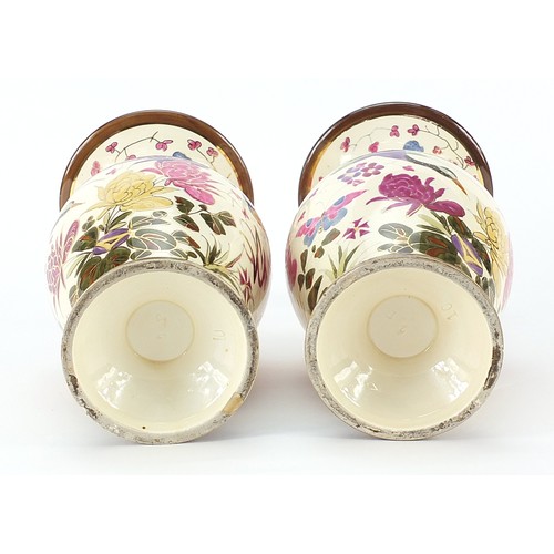 322 - Pair of continental pottery vases, probably by Zsolnay Pecs hand painted with butterflies and flower... 