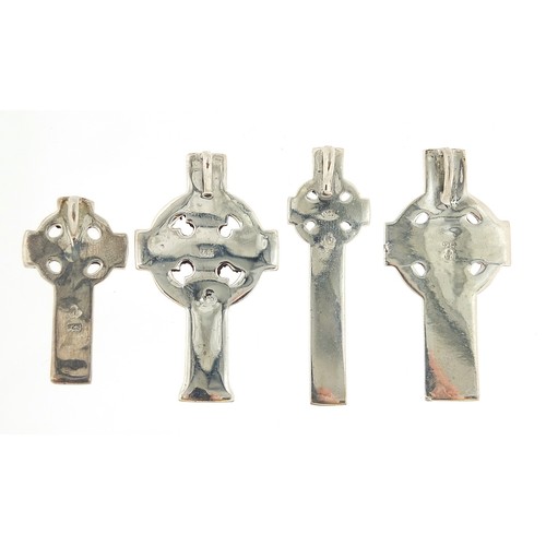 1141A - Four silver Celtic cross pendants, the largest 5cm high, total 35.0g