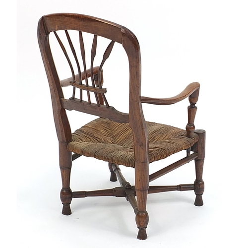 673A - Antique elm child's chair with rush seat, 48cm high